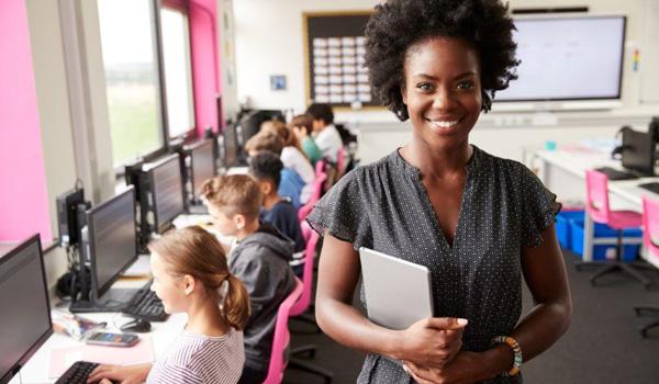 teacher smiling with students